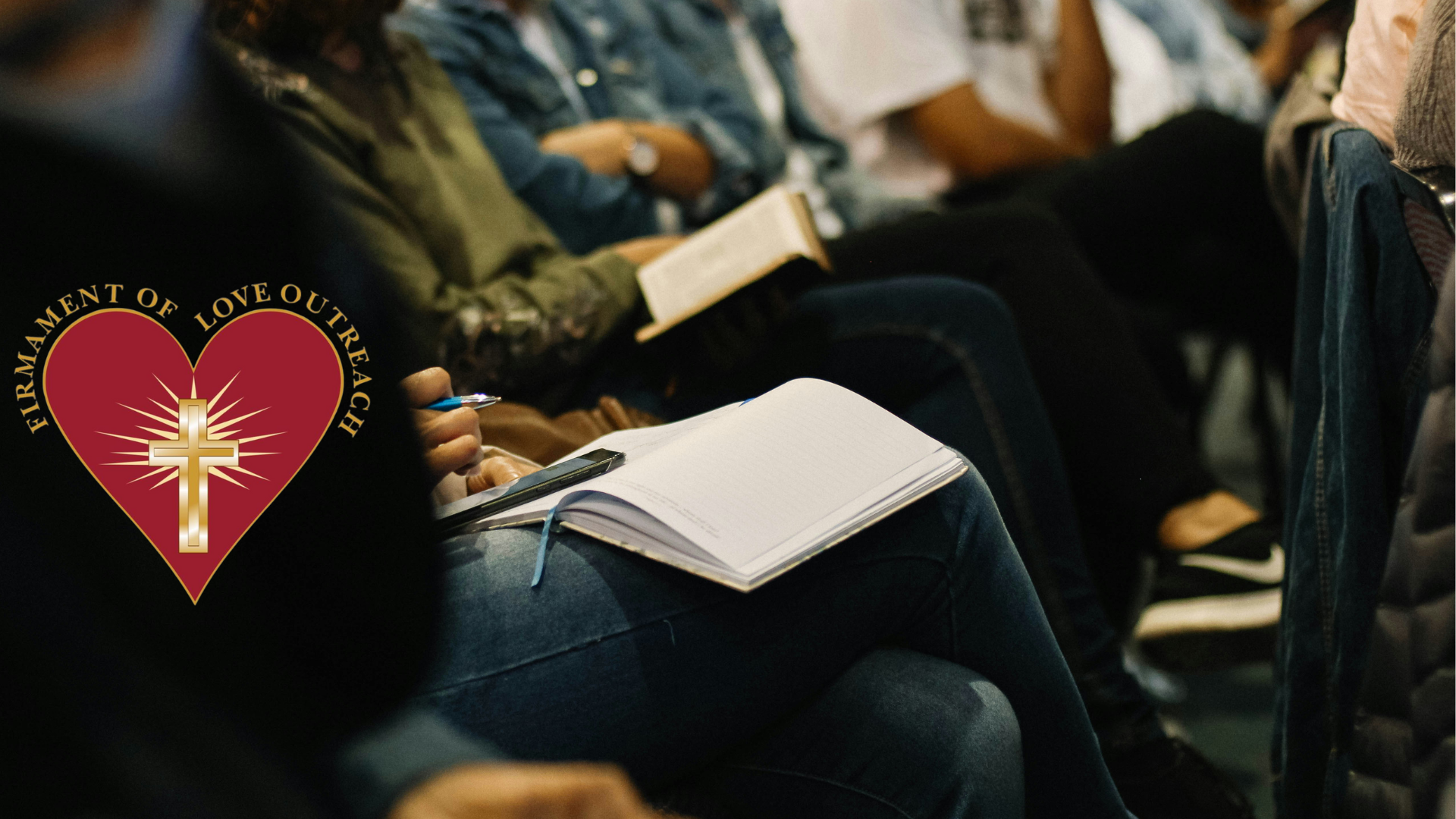 A group of people are sitting in a row holding bible and notebooks.