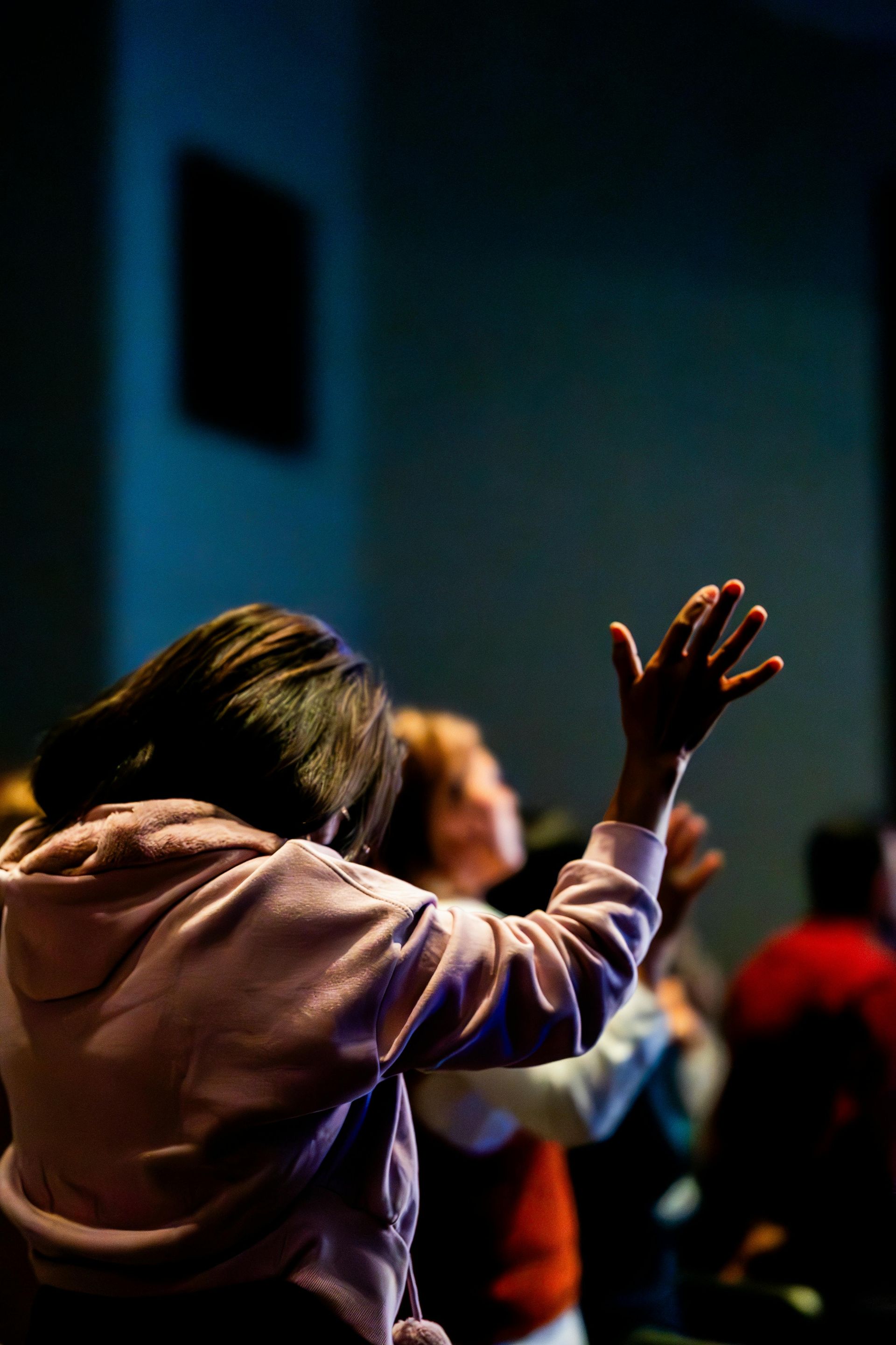 A woman singing into a microphone in front of a screen that says morning loves me