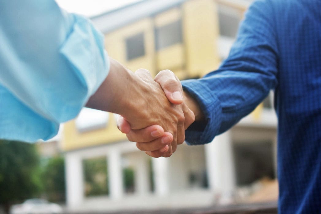 Image of two people shaking hands