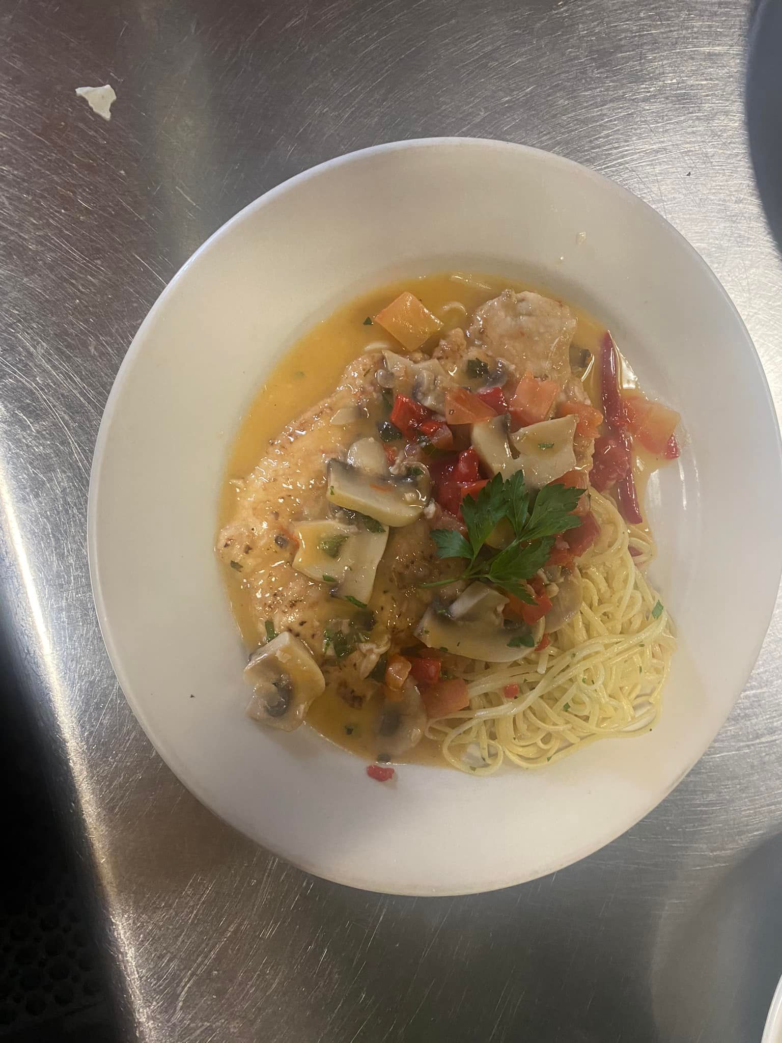 A plate of food with noodles and meat on a table.