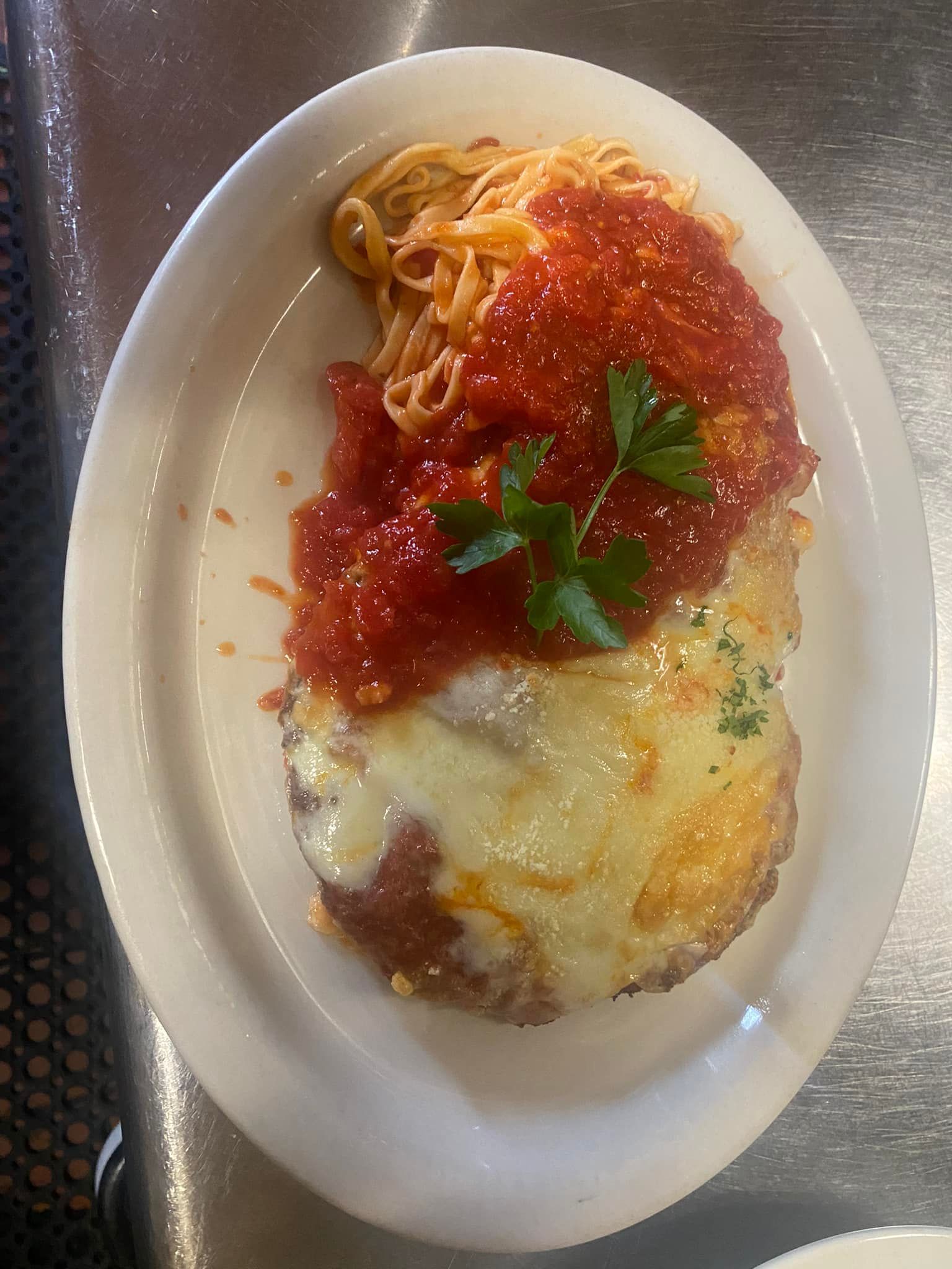 A plate of food with spaghetti and meat on a table.