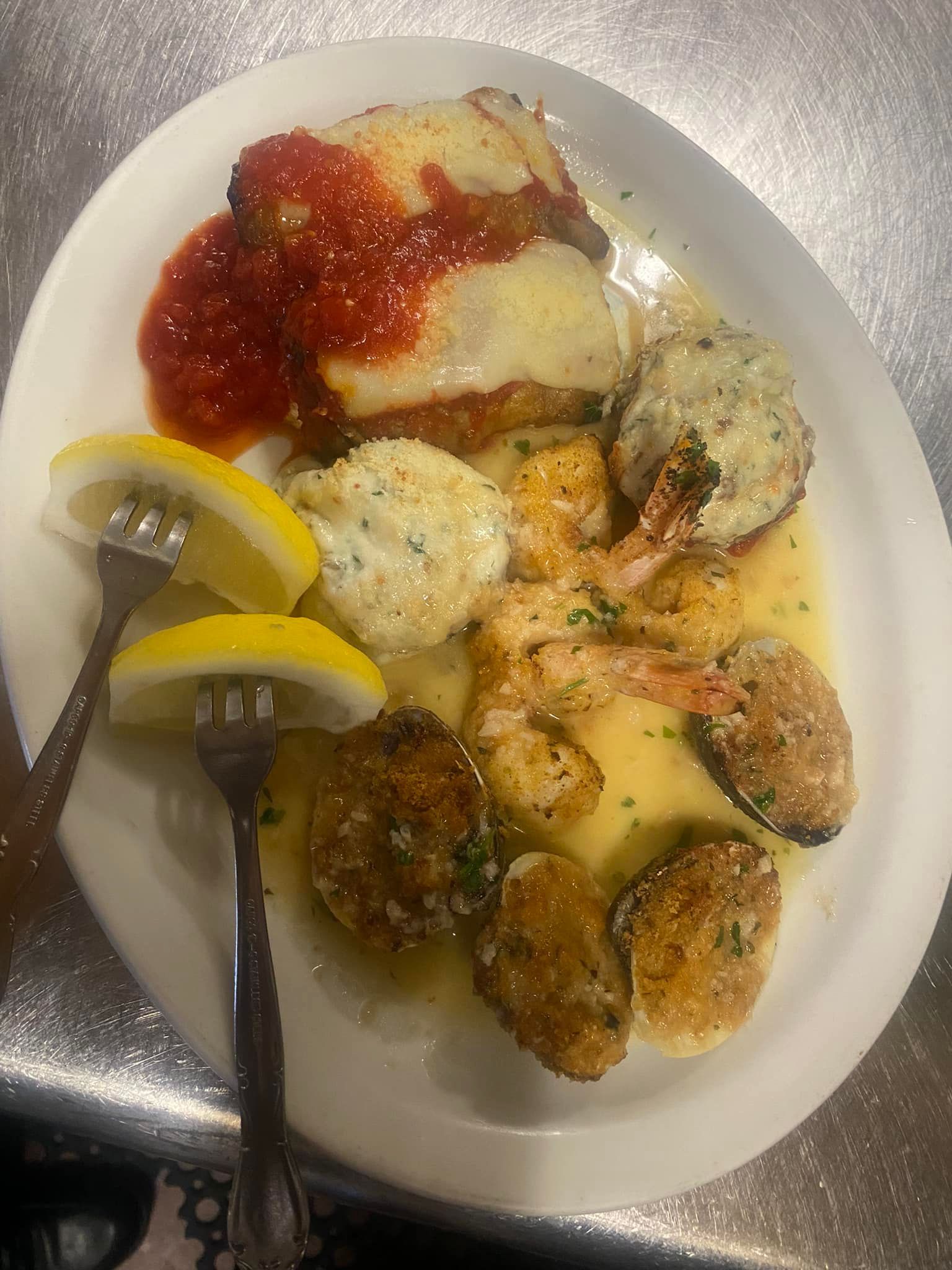 A plate of food with a fork on a table.