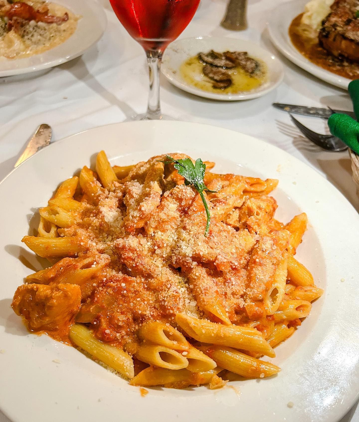 A plate of pasta with sauce and cheese on a table