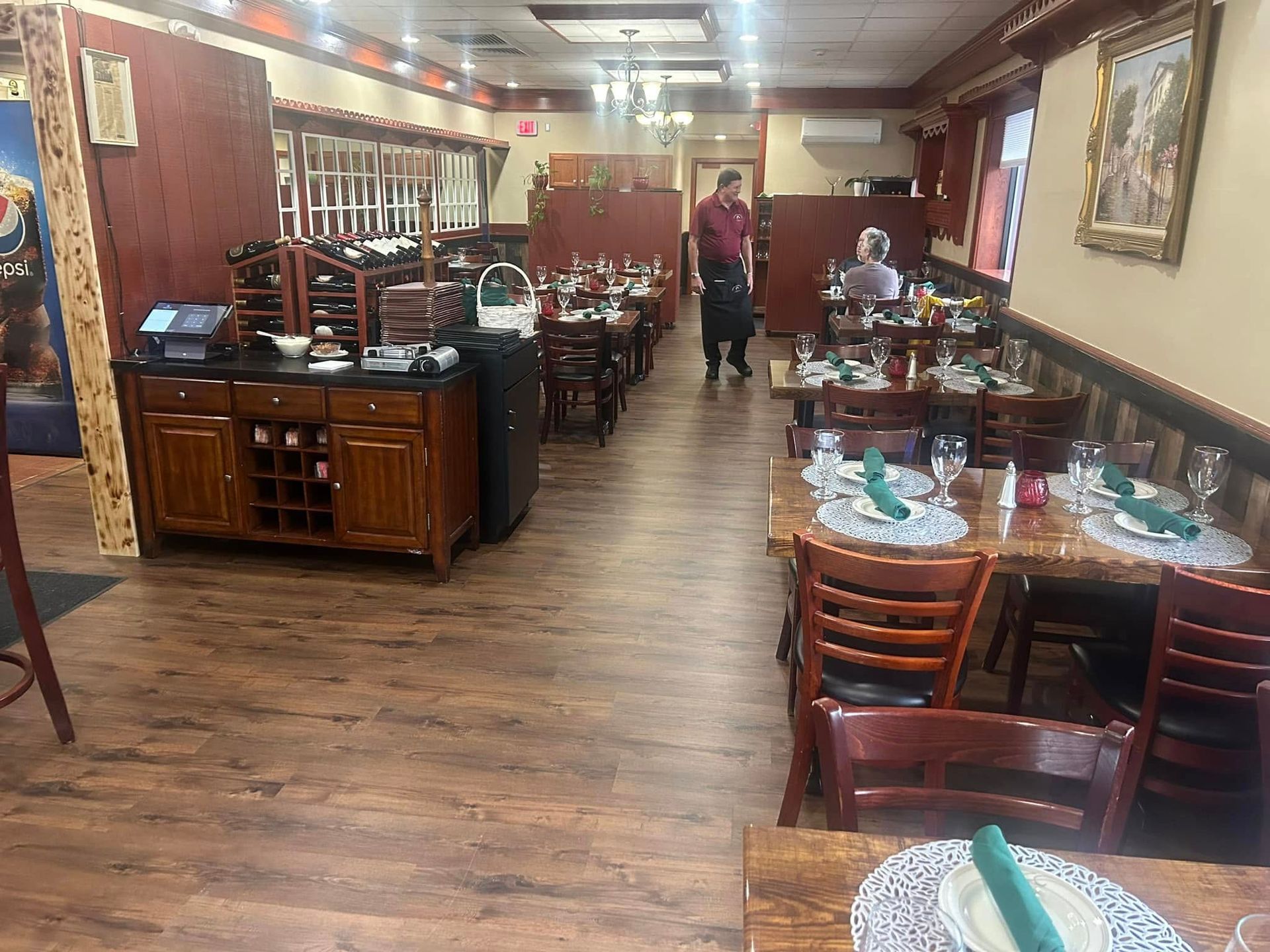 A restaurant with tables and chairs and a buffet.