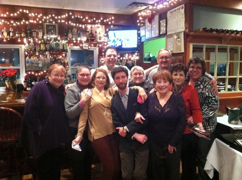 A group of people are posing for a picture in a restaurant.