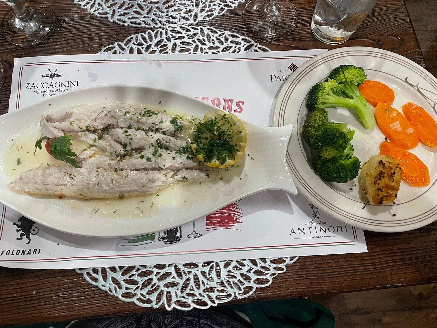 A plate of food with broccoli and carrots on a table.