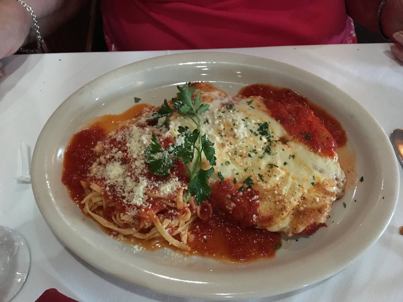 A plate of food with spaghetti and meat on a table