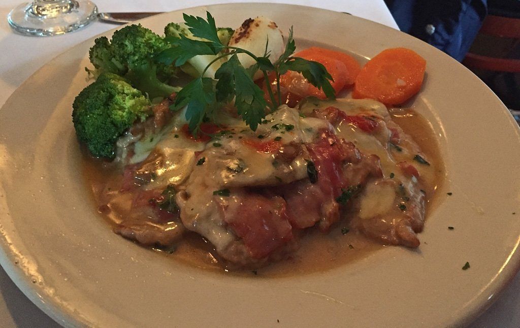 A plate of food with broccoli and carrots on it