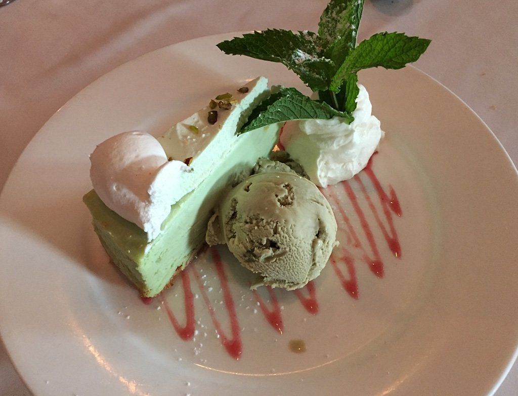 A white plate topped with a piece of cake and ice cream