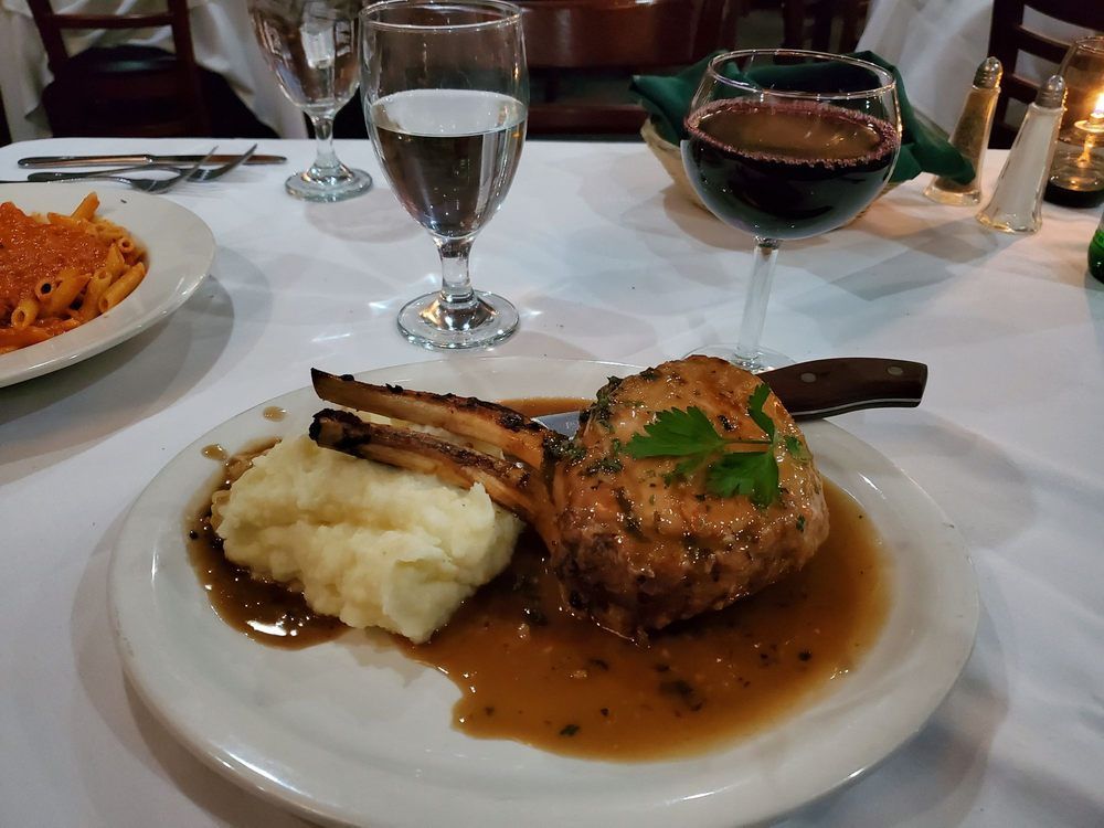 A plate of food with mashed potatoes and gravy on a table.