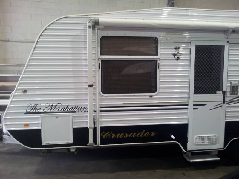 A Camper Is Parked In A Garage — Lake Macquarie Caravan Repairs In Cardiff, NSW