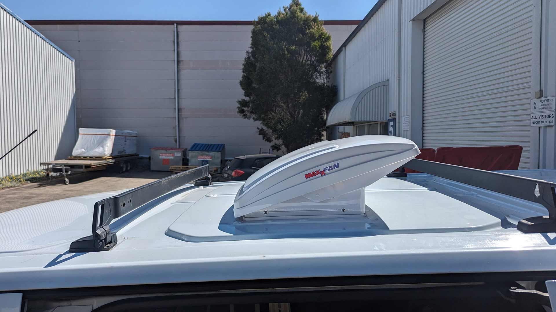 A White Van With A Roof Fan On Top Of It — Lake Macquarie Caravan Repairs In Cardiff, NSW
