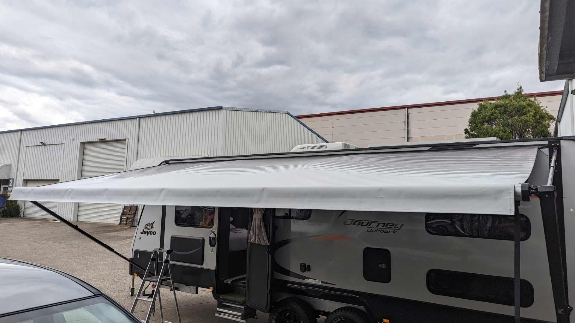 A RV With An Awning Attached To It — Lake Macquarie Caravan Repairs In Cardiff, NSW