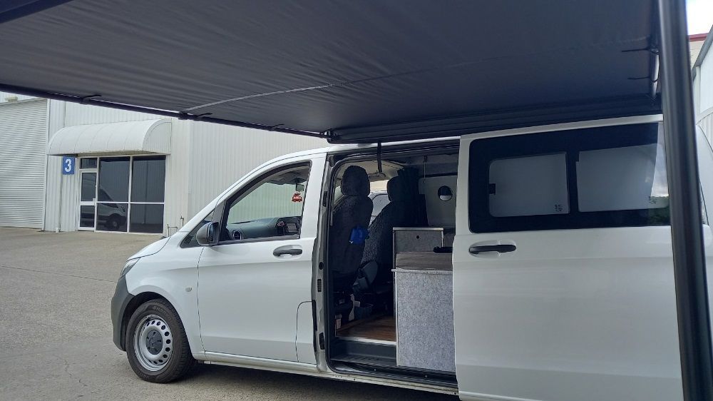 A White Van With Its Doors And Awnings Open — Lake Macquarie Caravan Repairs In Wyong, NSW
