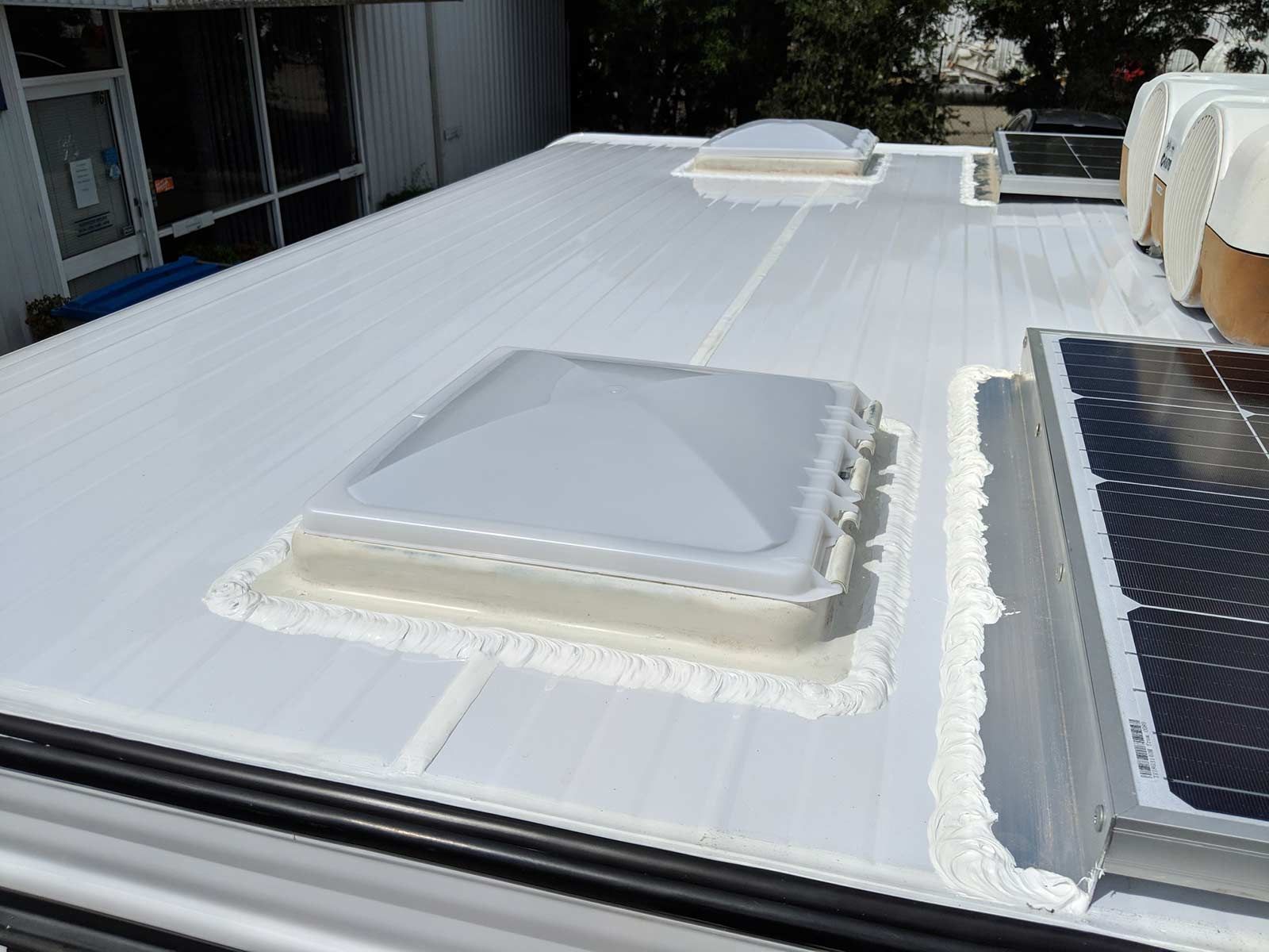 Top Of A Trailer With Two Skylights And A Solar Panel On It — Lake Macquarie Caravan Repairs In Cardiff, NSW