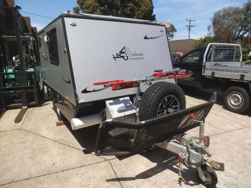 A Camper Trailer Is Parked Beside The Truck — Lake Macquarie Caravan Repairs In Cardiff, NSW