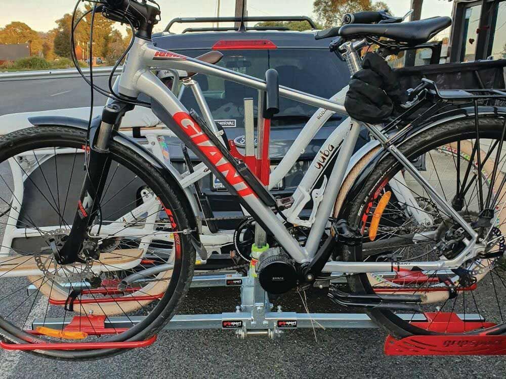 A Bicycle Is Attached To A Rack On The Back Of A Car — Lake Macquarie Caravan Repairs In Cardiff, NSW
