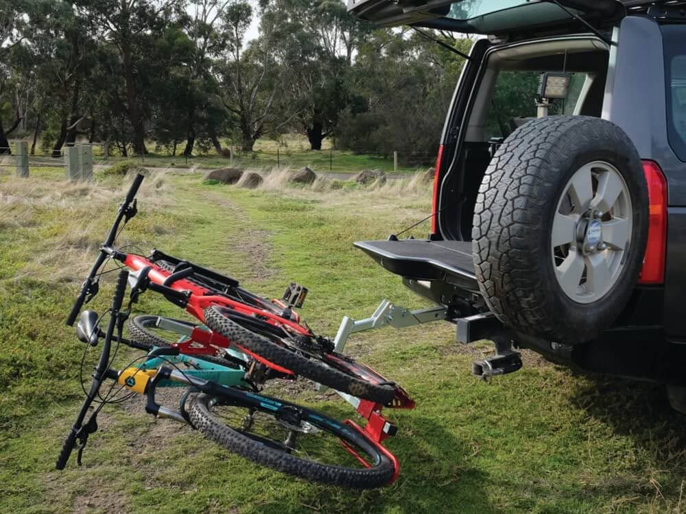 A Bicycle Is Attached To The Back Of A Car — Lake Macquarie Caravan Repairs In Newcastle, NSW