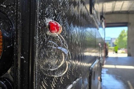 A Camper Van is Parked on the Side of the Road in Front of a Mountain — Lake Macquarie Caravan Repairs In Cardiff, NSW