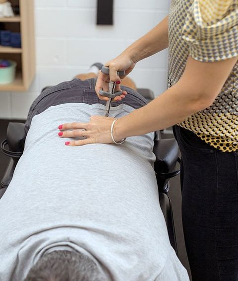 Man Having Chiropractic Back Adjustment — Activator Method