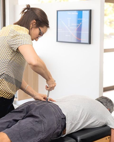 Patient Receiving Chiropractic Back Adjustment — Activator Method