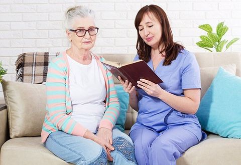 Elderly Woman Sitting With Nurse — Manual Adjustments