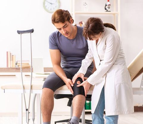 Patient With Knee Injury Visiting Doctor — Products
