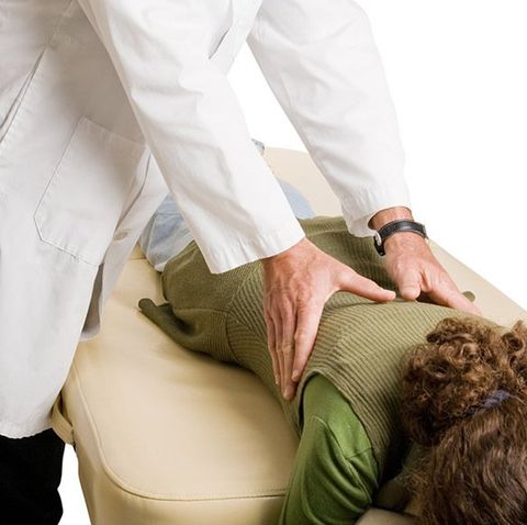 Chiropractor Doing Adjustment on Female Patient — Sacro-Occipital Technique