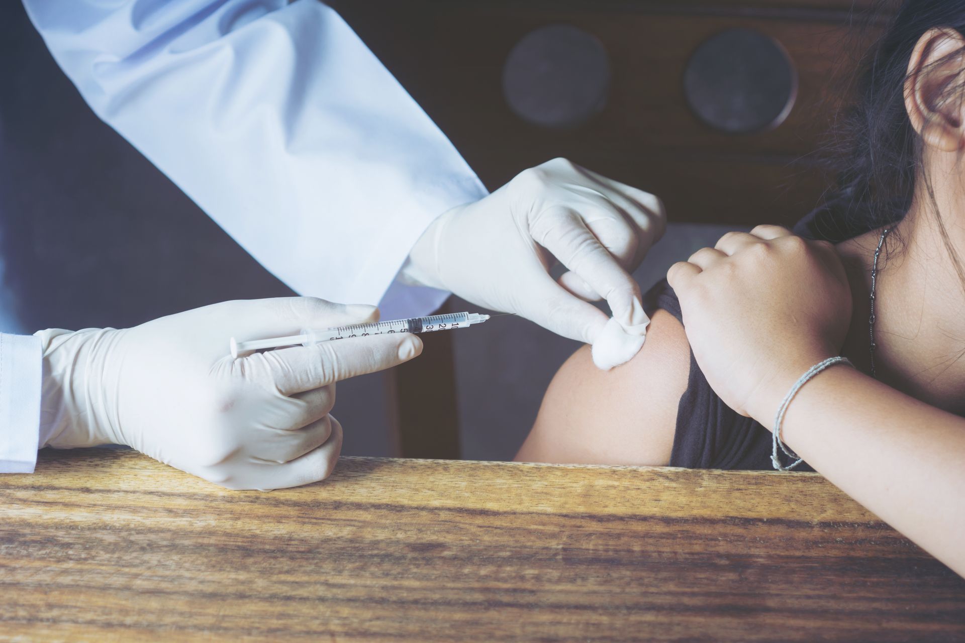 A patient is getting allergy shots from her doctor to get long-term relief from her allergies.