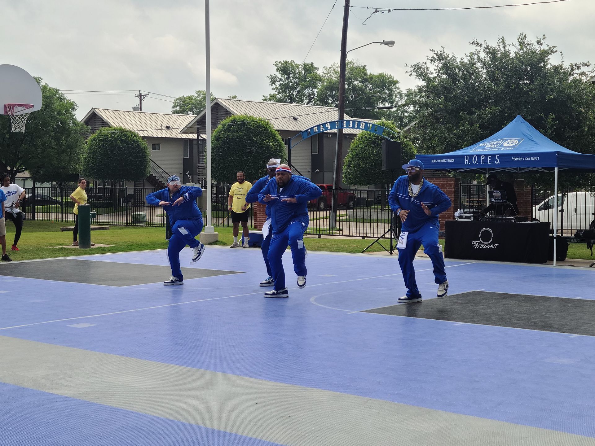 A group of men are dancing on a basketball court