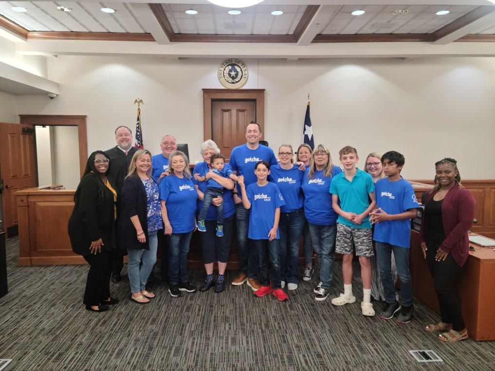 A group of people are posing for a picture in a courtroom.
