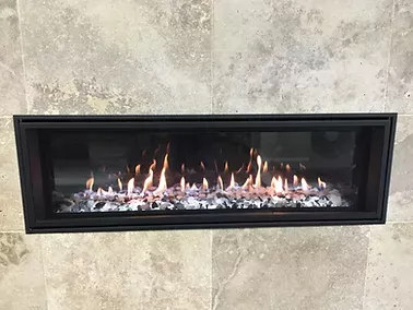 finished fireplace by dwr services with flames coming out of it is on a tiled wall 