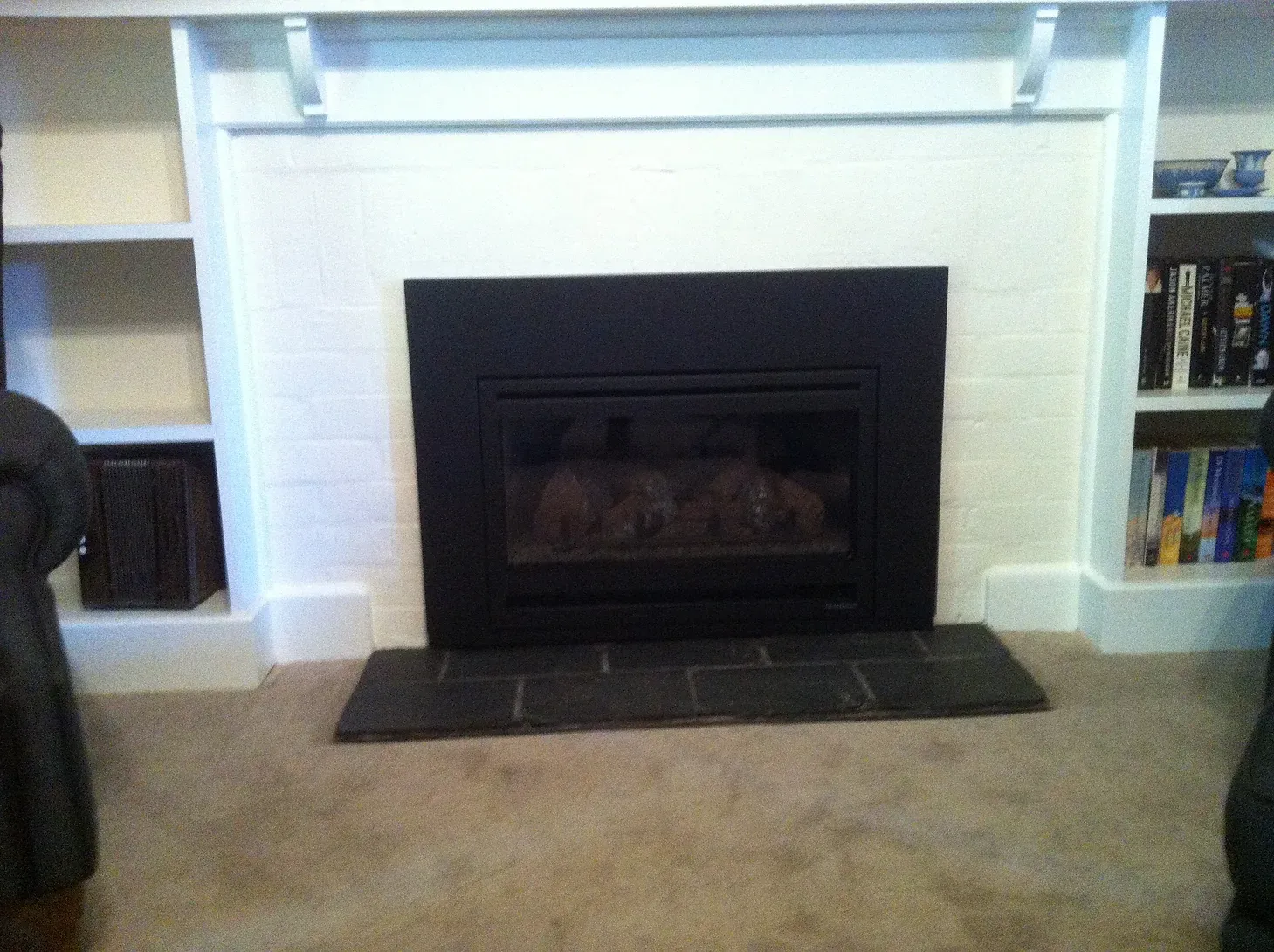 brick mantle painted white with black fireplace built in