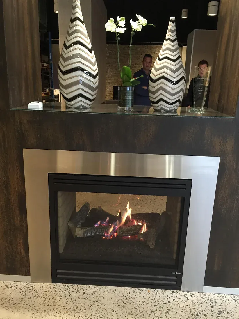 a fireplace with two vases on top of it