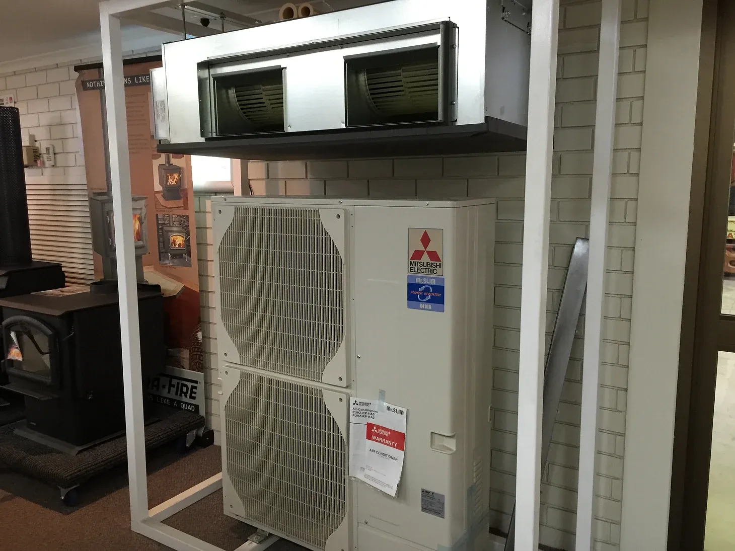 mitsubishi electric air conditioning unit with warranty label on display at dwr services 