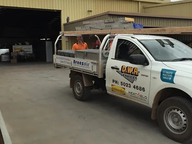 ute with DWR Services branding on the side in front of a shed