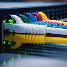 A bunch of colorful ethernet cables are connected to a server.