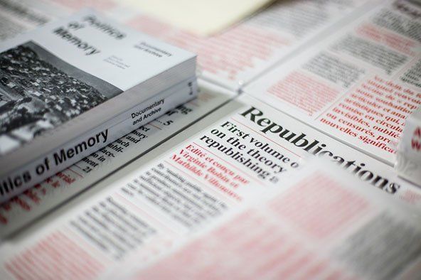 alcuni fogli stampati con scritte rosse e nere e accanto un libro