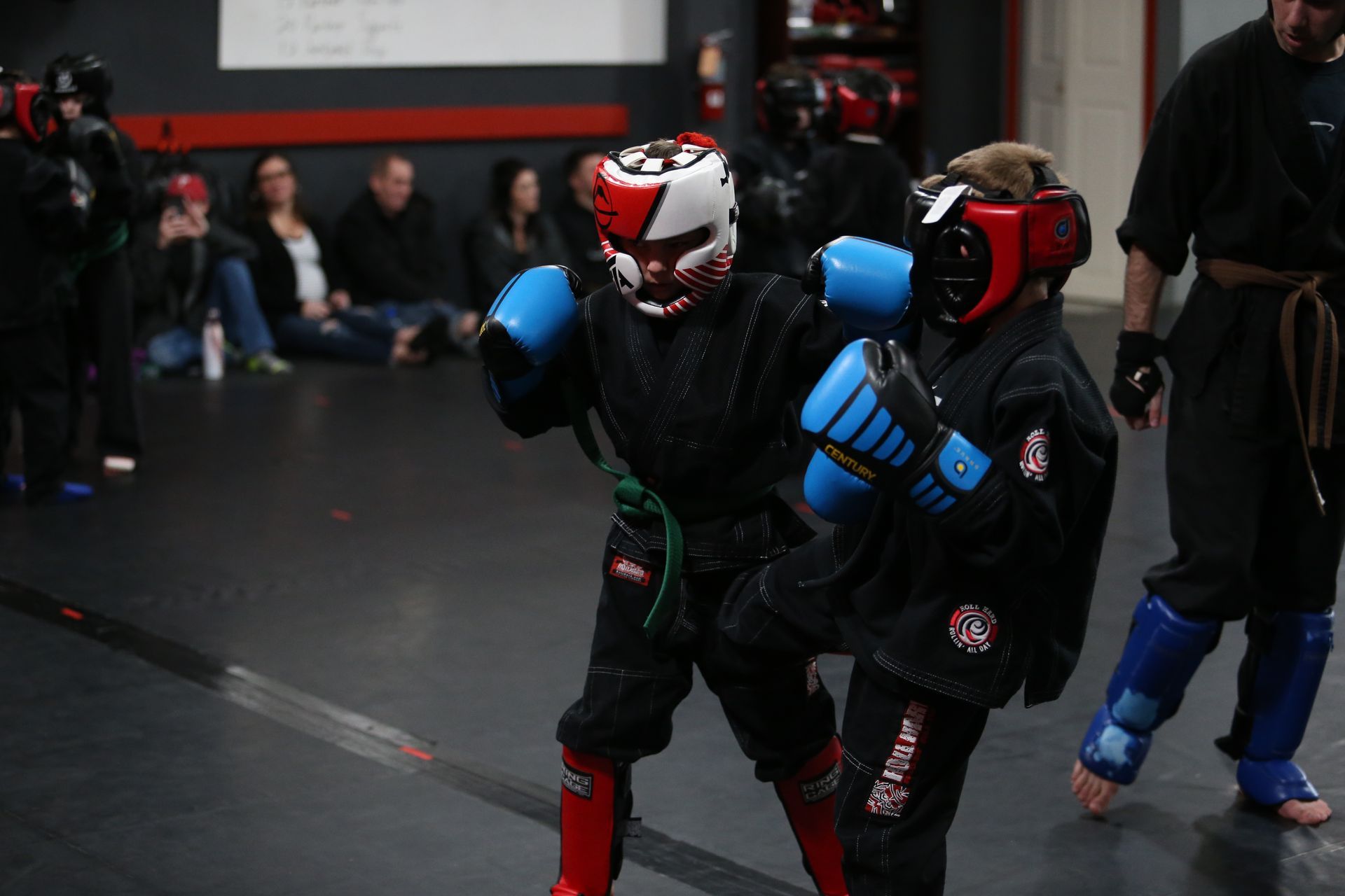 two young boys wearing boxing gloves with the word king on them