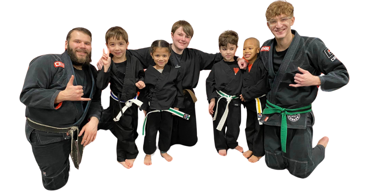 a group of young people in karate uniforms are posing for a picture .