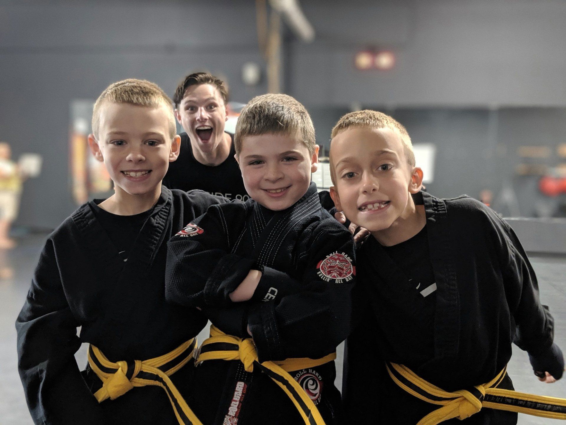 a group of young boys are posing for a picture in a gym .