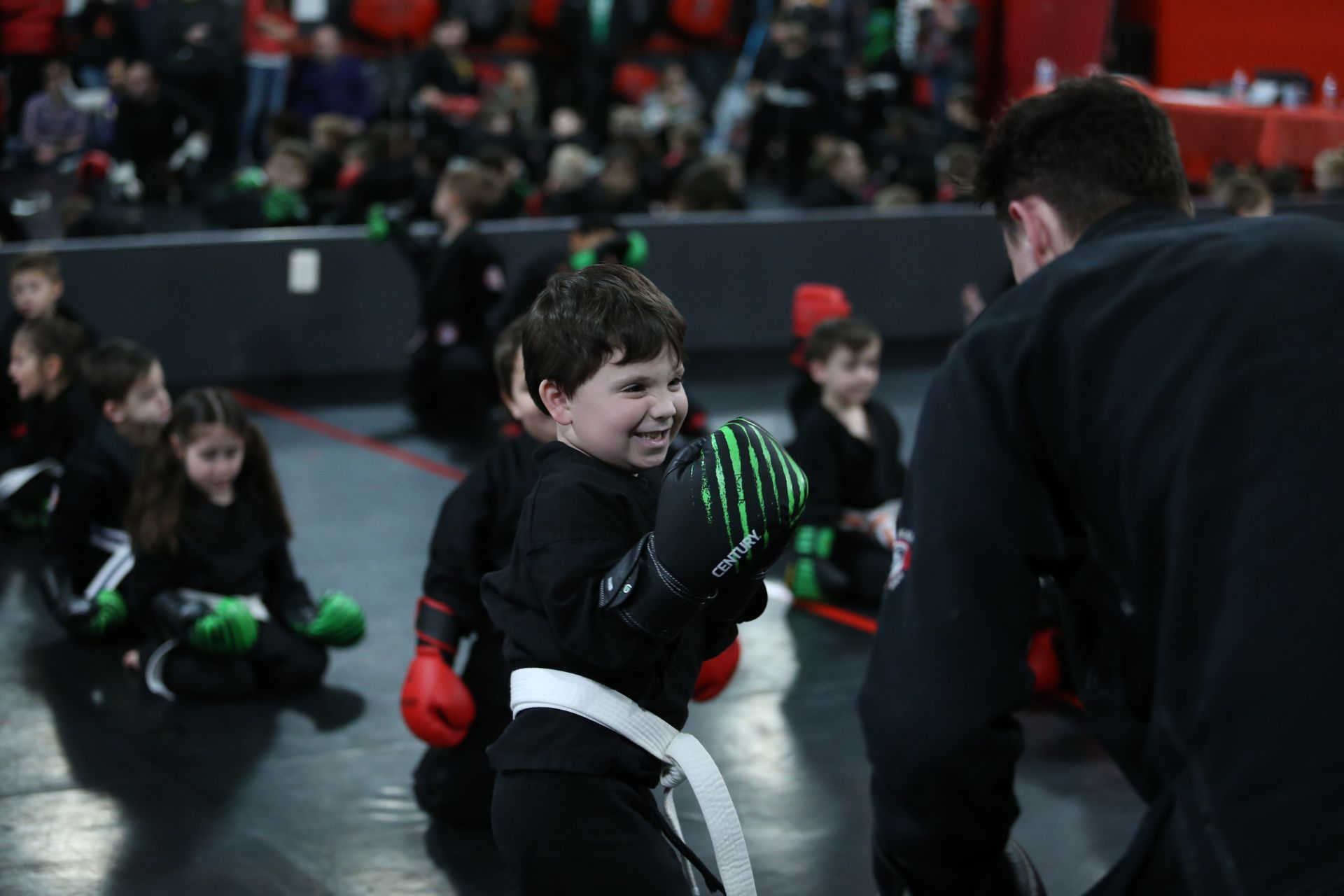 a young boy wearing a pair of gloves that say o'neill