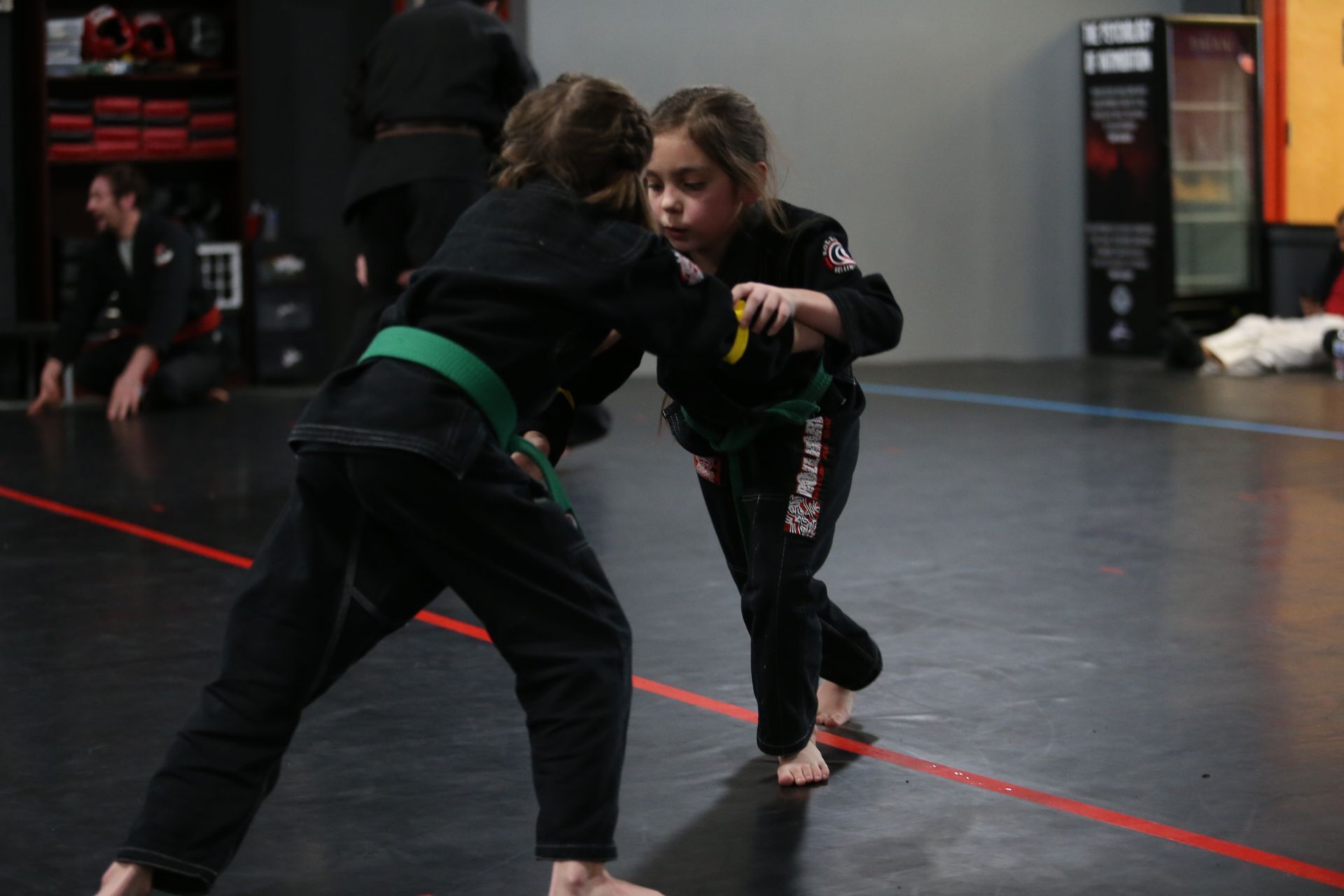 a girl wearing a green belt that says karate on it