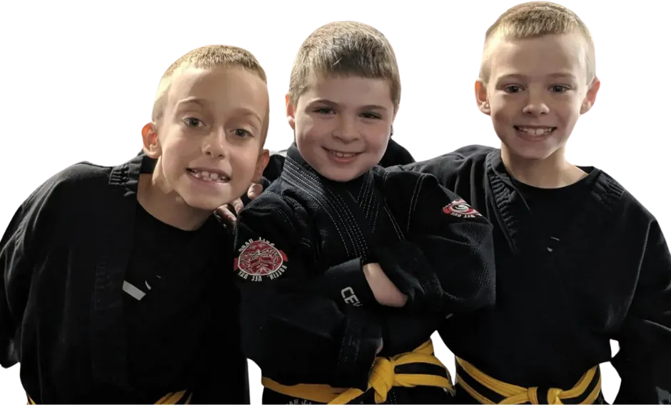 three young boys are posing for a picture together .