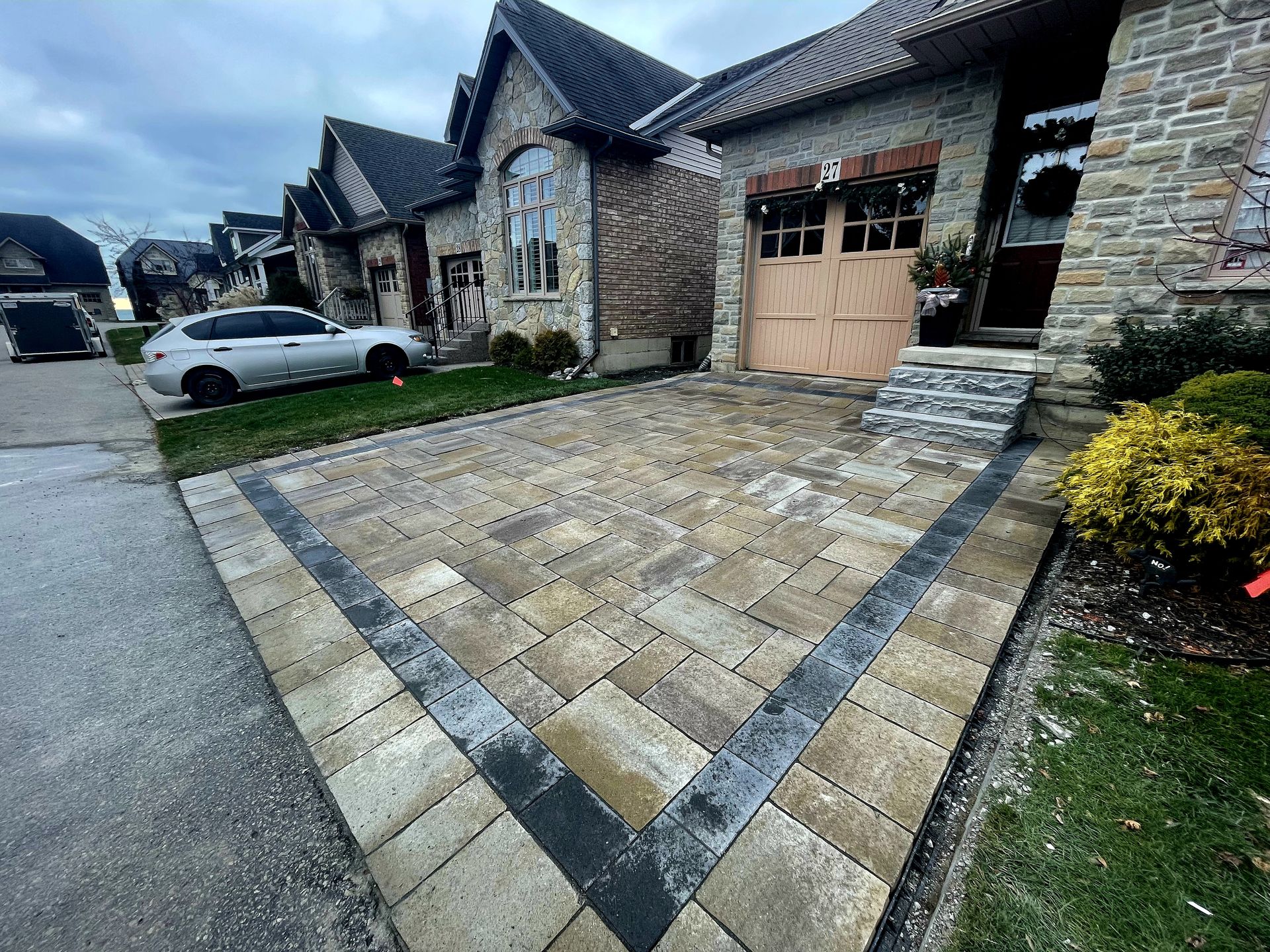 a car is parked in a driveway in front of a house .
