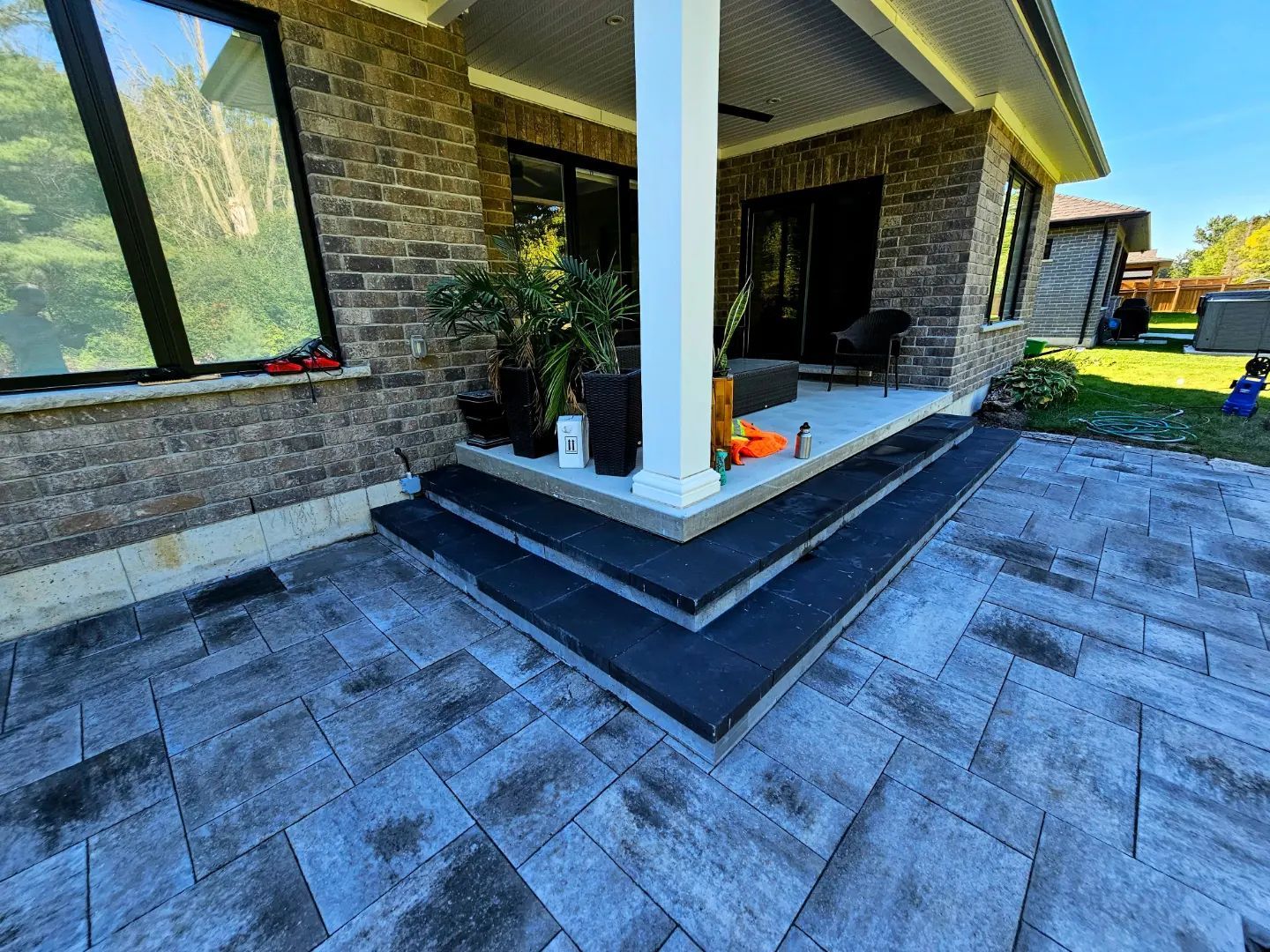 a brick house with a patio and stairs in front of it .