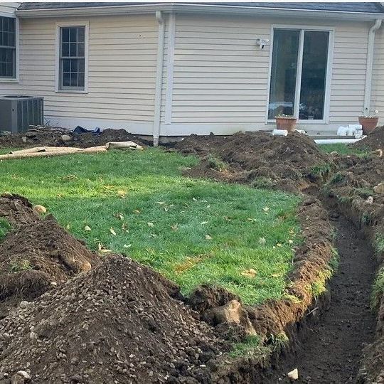 a large pile of dirt is sitting in front of a house .