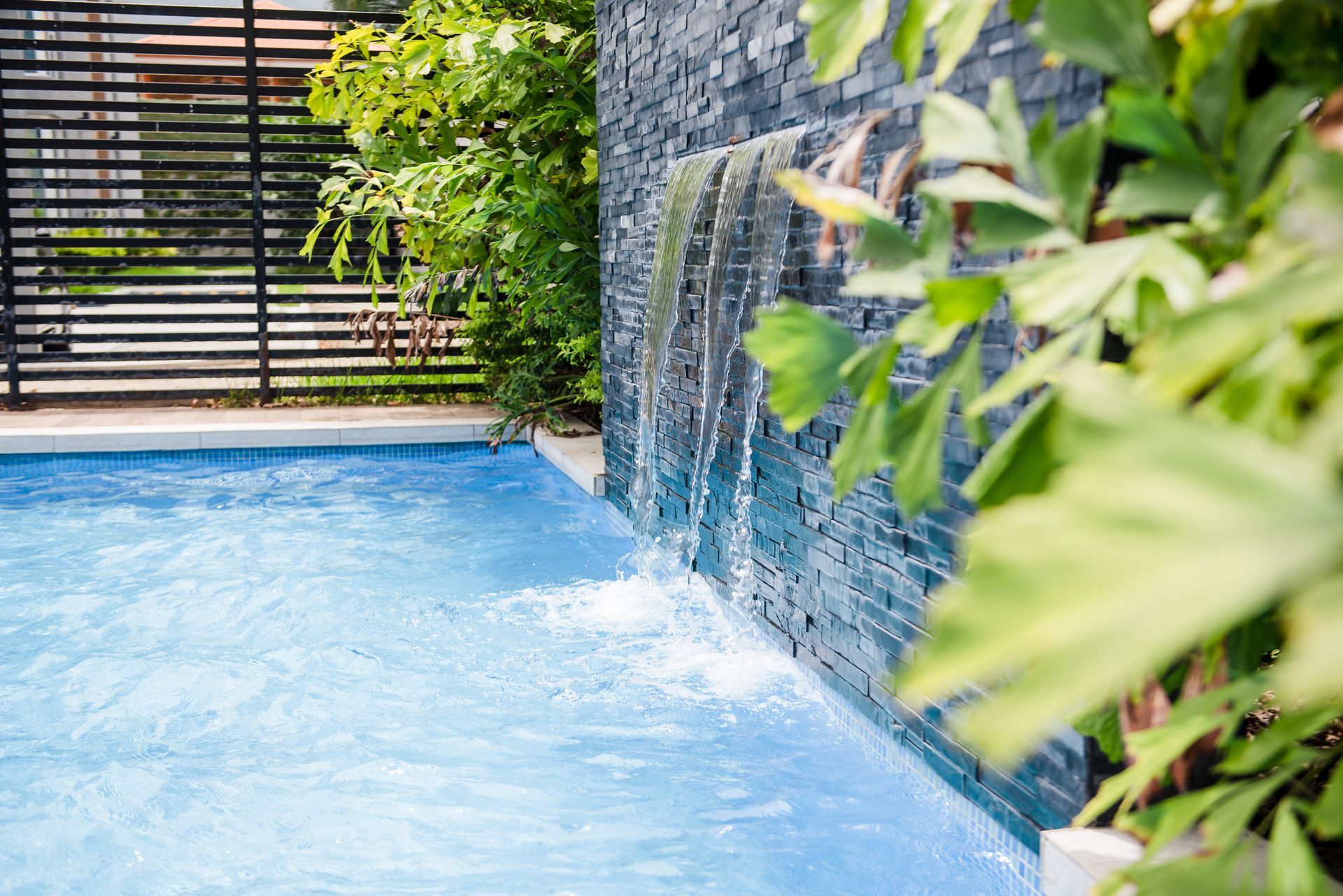 there is a waterfall in the middle of the pool.