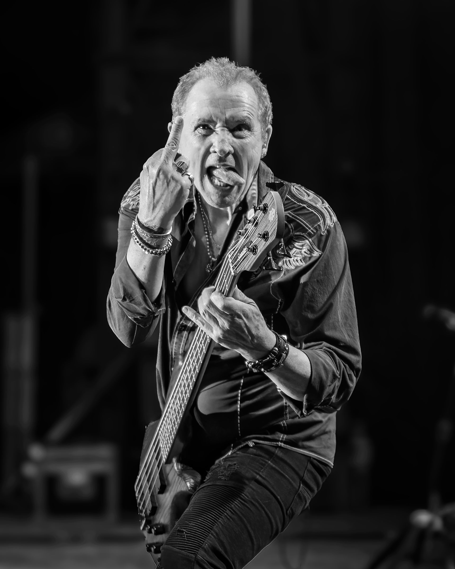 A black and white photo of a man playing a guitar