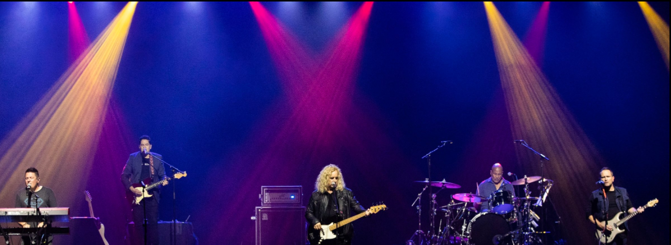A group of people playing instruments on a stage with the word radio above them